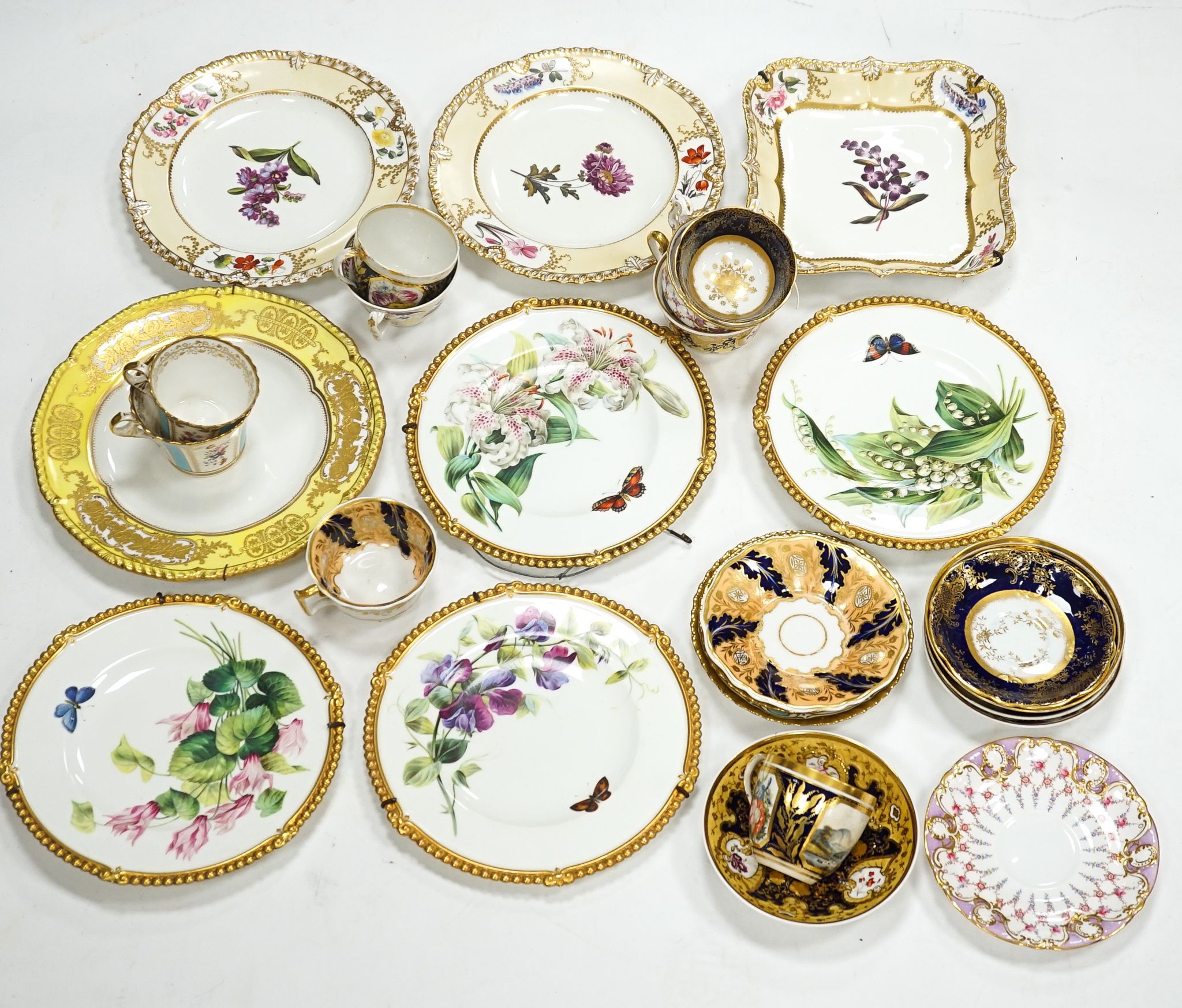 A small collection of Victorian porcelain tea cups and saucers and sundry dessert plates